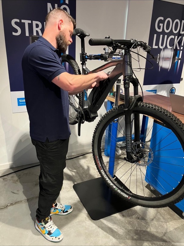 Dan working on a mountain bike in a service stand