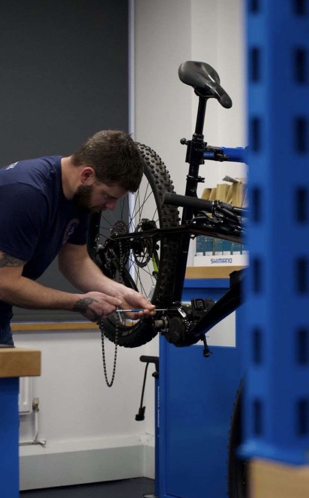 Dan making an adjustment to a bike in the workshop